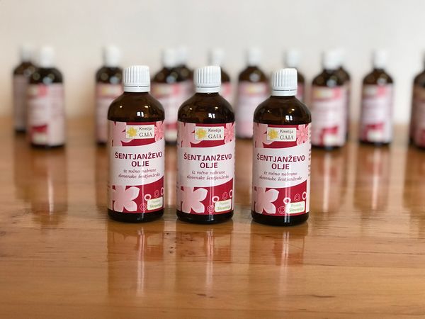Image showing labeled bottles of St. John's Wort oil, with more bottles in the background.